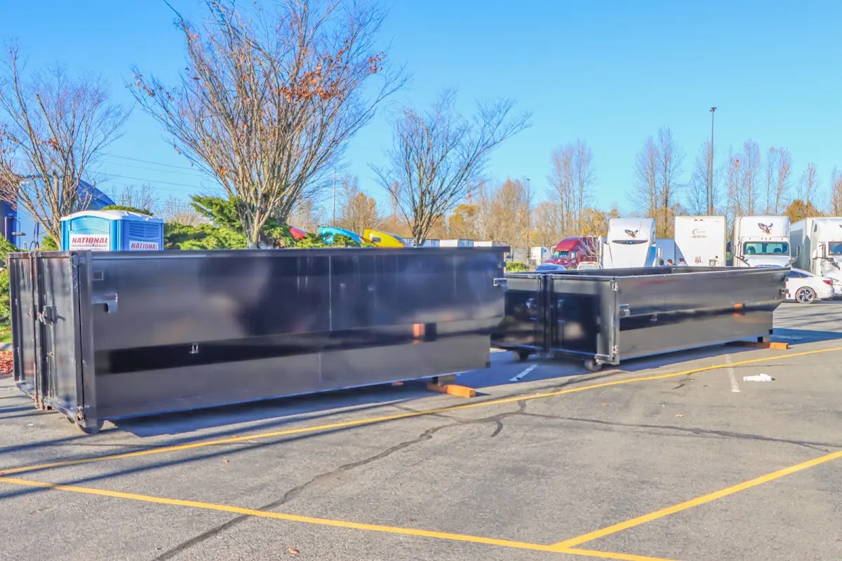 Professional dumpster rental service with roll-off container on residential driveway in Warrington